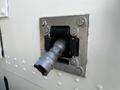 A metal coupling attached to a rectangular outlet on a 2009 Morgan Olson Workhorse vehicle