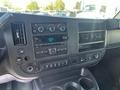 Dashboard of a 2012 Chevrolet Express featuring radio controls climate controls and various switches
