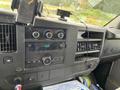 Interior dashboard of a 2014 GMC Savana featuring a radio control panel air conditioning vents and various console buttons