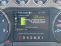 A digital display showing fuel information for a 2016 Ford F-550 with a remaining range of 124 km an average fuel consumption of 29.2 L per 100 km and total distance driven of 230899.7 km