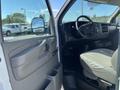 Interior view of a 2013 Chevrolet Express showing the driver's side door panel and dashboard with steering wheel and seat