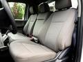 Interior view of a 2022 Ford F600 with two spacious gray fabric front seats showing detailed stitching and modern design