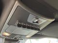 The interior view of a 2019 Ford F-150 ceiling featuring a control panel with multiple auxiliary switches and a small button