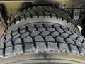 Close-up of two heavy-duty tires on a 2017 International WorkStar 7600 showing deep treads designed for traction and stability