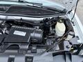 Engine compartment of a 2016 GMC Savana showing the engine block various components and fluid reservoirs