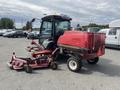 A red 2014 Toro Groundmaster 5910 with a cab and attached mowing deck parked in a lot