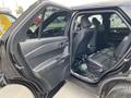 A 2021 Ford Explorer with an open rear door showcasing the interior seating and door panel design