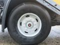 A close-up view of a white wheel on a 2016 Freightliner 108SD truck featuring a black tire with visible tread and text indicating the brand and model