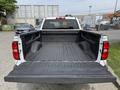 A 2018 Chevrolet Silverado 1500 with an empty truck bed featuring a rubberized liner and side walls that are high enough for secure storage