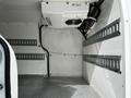 Interior of a 2019 Ford Transit Connect showing a spacious cargo area with metal shelving and a mounted cooling unit on the ceiling