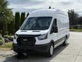 2021 Ford Transit a large white van with a high roof and a black grille parked on a driveway