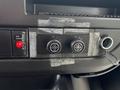 Control panel of a 2020 Chevrolet Express featuring buttons for rear door and climate settings with a key slot and some tape remnants on the surface