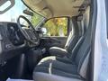 Interior view of a 2019 GMC Savana showing the driver and passenger seats the dashboard and gear shifter