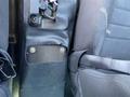 A close-up view of the interior of a 2019 Dodge Charger showing the seat and console area with exposed fasteners and wires