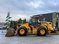 A 2008 Hyundai XG 350 with a beige body and large front loader bucket parked on a flat surface