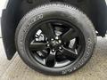 Close-up of a black alloy wheel with a Goodyear Wrangler tire mounted on a 2022 RAM 1500 Classic