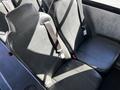 Interior seats of a 2022 Blue Bird Vision school bus featuring black upholstery and safety seatbelts