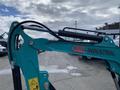 2024 AGT Industrial QH13R Mini Excavator with a teal frame and hydraulic arm visible at the forefront