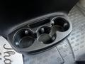 A black cup holder with four circular compartments designed to hold beverages in a 2017 RAM Promaster