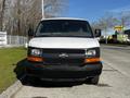 A 2015 Chevrolet Express van with a white exterior and black grille parked facing forward