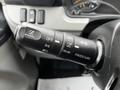 Close-up of the control lever in a 2021 Mitsubishi FE featuring buttons for cancel off set auto resume and pass up