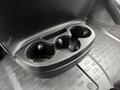 A black cup holder in the front console of a 2021 RAM Promaster designed to hold two drinks