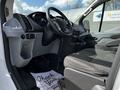 Interior view of a 2018 Ford Transit highlighting the driver's seat steering wheel dashboard and center console