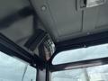 Interior view of a 2024 AGT Industrial Green QH13R Mini Excavator featuring controls and a display panel mounted in the cab's ceiling