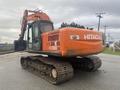 2006 Hitachi ZX200LC excavator with a large orange body and rubber tracks positioned on a gravel surface