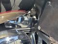 Close-up view of a polished chrome engine component of a 2004 Harley-Davidson FLHTCUI motorcycle with a leather seat and shiny metallic details