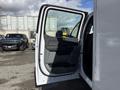 A 2024 Ford F-550 with the driver's side door open showing the interior door panel and seating area