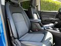 Two front seats of a 2021 Chevrolet Colorado with a modern design featuring gray fabric and leather accents