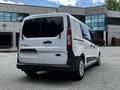 A white 2016 Ford Transit Connect van parked with tinted rear windows and a smooth exterior design