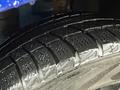 Close-up of a wet tire tread of a 2020 Dodge Grand Caravan showing detailed patterns and grooves for traction