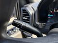 A close-up view of the turn signal and wiper control lever in a 2016 Ford F-150