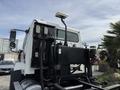 A white 2016 Freightliner 108SD truck with a visible rear chassis design and various mounted equipment including lights and hydraulic components