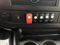The image shows the control panel of a 2020 Chevrolet Express featuring various switches including a red door control switch and several black buttons for different functions