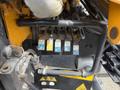 A close-up view of hydraulic control levers with color-coded symbols attached to a 2011 International 4300 truck chassis