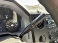 Close-up of the interior controls of a 2015 Ford F-550 featuring a gear shift lever and dashboard instruments