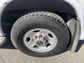 A close-up of the tire and wheel of a 2016 GMC Savana showing a Michelin tire tread and a silver wheel with black GMC logo