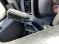 Close-up of a 2012 Freightliner M2 112 steering column control lever featuring markings for off push pull and flash options