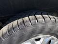 Close-up of a tire on a 2016 Ford Transit displaying a tread pattern with significant wear and a silver alloy wheel