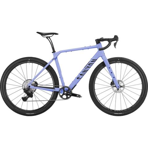 2026 Canyon Grizl CF 8 Di2 Carbon Adventure Gravel Bike in light purple featuring a sleek frame disc brakes and rugged tires designed for off-road cycling