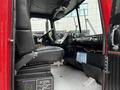 Interior view of a 1991 Sutphen Deluge fire truck showing the driver's seat dashboard controls and equipment