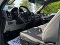 Interior of a 2017 Ford F-250 SD showing the dashboard steering wheel and seats in a light gray color