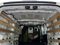 Interior view of a 2023 Ford Transit van showing a spacious cargo area with wooden slats for securing loads and a partition at the back