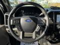 Steering wheel of a 2021 Ford F-550 with controls on the sides and the Ford logo in the center