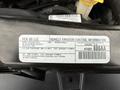 A 2017 Dodge Grand Caravan with a label showing vehicle emission control information and specifications regarding fuel and regulations