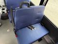 A blue upholstered seat with a seatbelt in a 2020 Chevrolet Express van interior