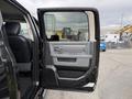 A 2018 RAM 1500 with the driver's side door open showcasing the interior door panel and seats